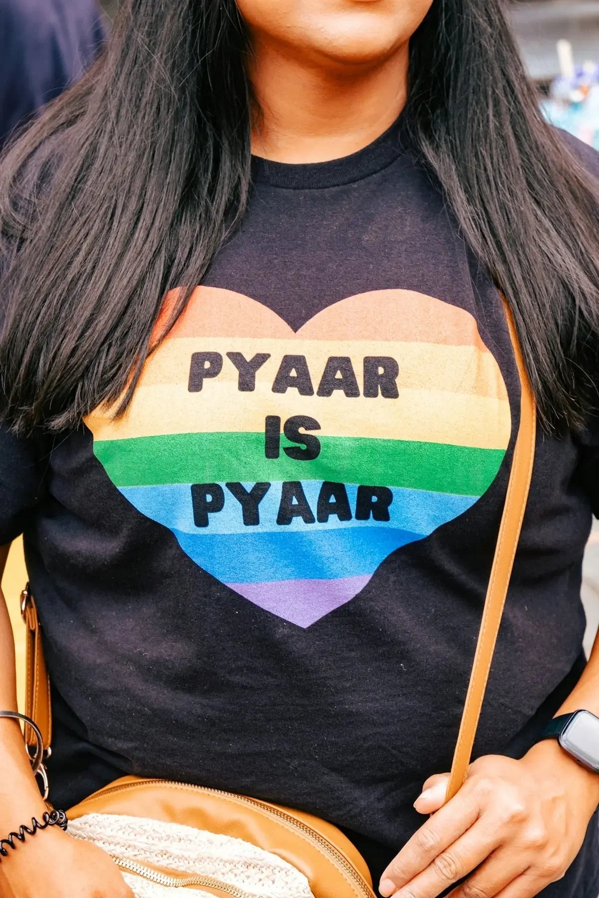 a woman is wearing a gay pride shirt